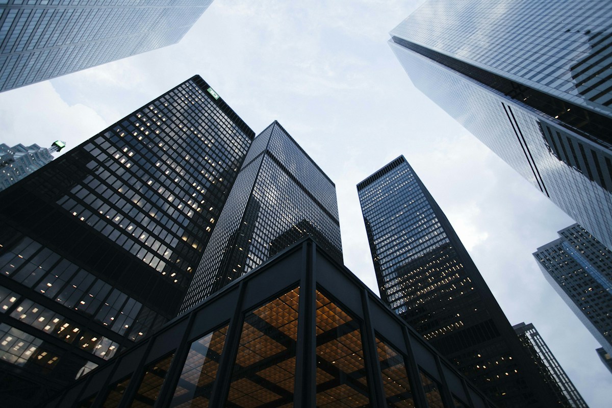 Looking upward through a district of modern glass office towers
